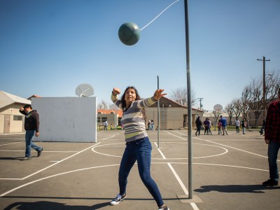 Lorena Hernandez whines us her arm to hit a tetherball during recess at Buttonwillow Union School on March 2, 2022. Two months ago students were required to wear masks on the playground. Photo by Larry Valenzuela for CalMatters