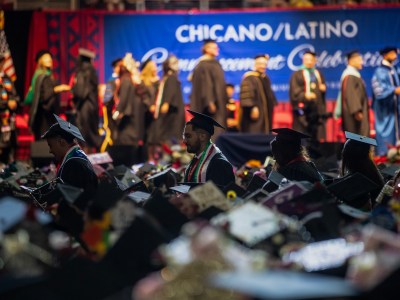 Student graduates walk through the aisles to receive their degrees at the Fresno State Chicano/Latino Commencement Celebration in the Save Mart Center in Fresno on May 18, 2024. Photo by Larry Valenzuela, CalMatters/CatchLight Local